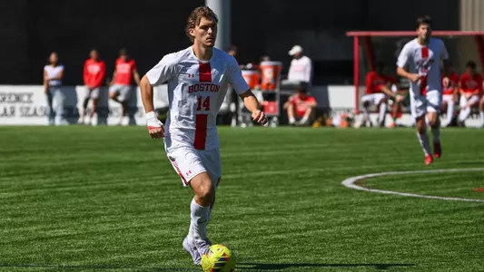 Quin DeLaMater dribbles the ball up the field against Navy