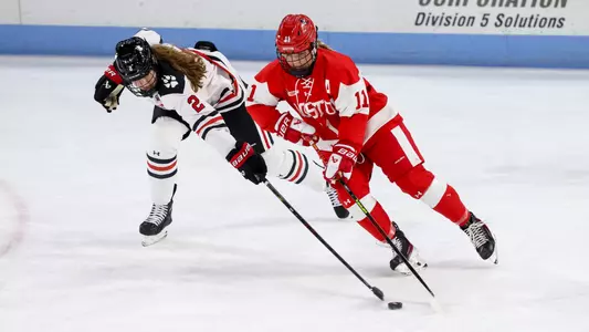 Sydney Healey playing hockey against Northeastern
