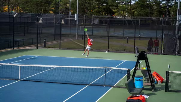 Andrew Andea hitting a serve at Harvard