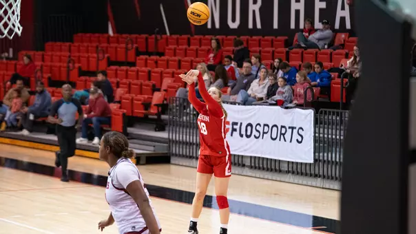 Photo of BU women's basketball sophomore Hildur Gunnsteinsdóttir shooting a three-pointer at Northeastern.