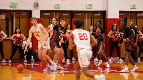Ben Defty dribbles the ball closer to the hoop while defended by a Bear