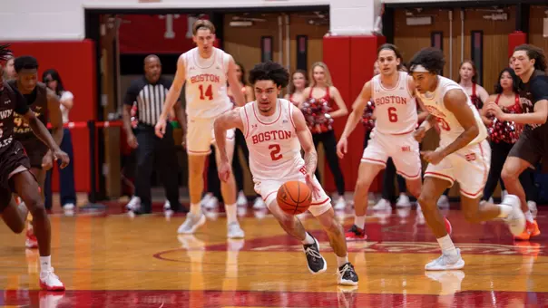 Chance Gladden brings the ball up the court during a fastbreak attempt with teammates following behind