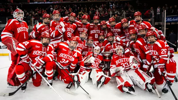 BU men's ice hockey team poses with the Kelley-Harkness Cup at Madison Square Garden after beating Cornell at the 10th edition of Red Hot Hockey