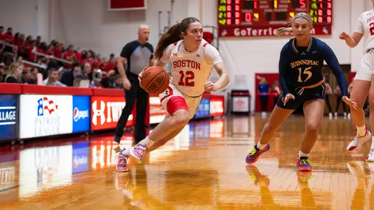 Photo of women's basketball junior Bella McLaughlin dribbling the ball at Case Gym.