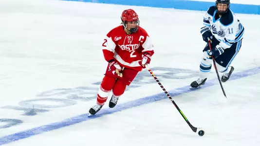 Maeve Carey skates with the puck at Maine