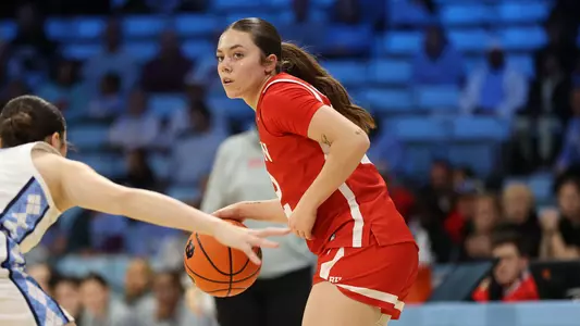 Photo of BU women's basketball junior Bella McLaughlin dribbling the ball at UNC.