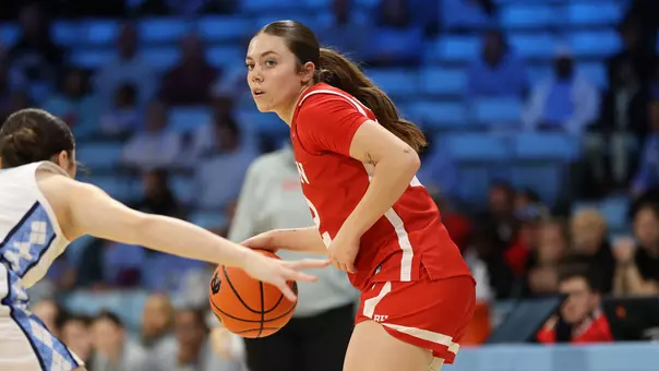 Photo of BU women's basketball junior Bella McLaughlin dribbling the ball at UNC.