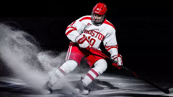 Jonathan Morello sprays snow as he stops on the blue line after being introduced before a BU hockey game