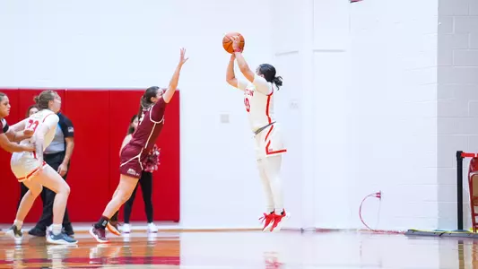 Photo of women's basketball senior Alex Giannaros shooting a three-pointer against Colgate.