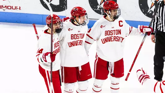 Cole Hutson, Sascha Boumedienne and Ryan Greene celebrate a goal together