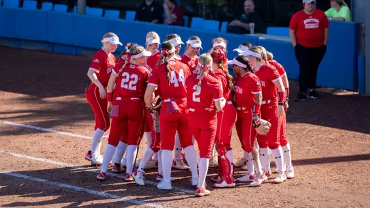 The softball team huddles together at the end of an inning at Florida Gulf Coast.
