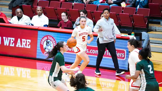 Photo of women's basketball sophomore Aoibhe Gormley dribbling the ball baseline at Case Gym.