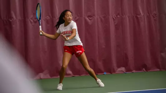 Madison Liu winding up to hit a forehand on a tennis court