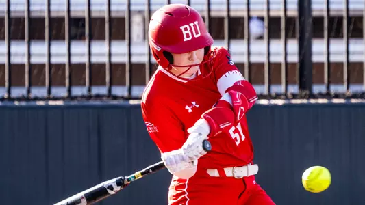 Kylie Doherty is swinging at a pitch at home plate.