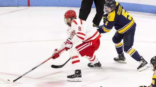 Brandon Svoboda skating with the puck against Merrimack