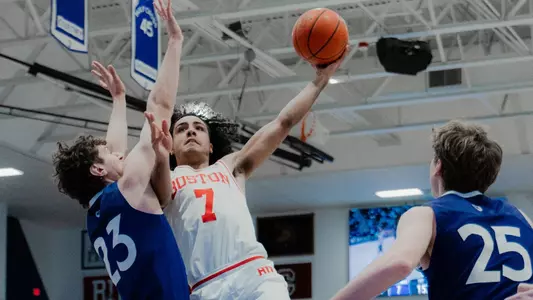 Azmar Abdullah attempts a leaping layup at Holy Cross.
