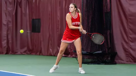Blanka DeMicheli hits a tennis ball in a match