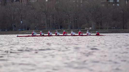 Photo of a BU Lightweight Rowing eight on the Charles River.