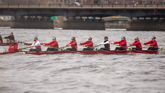 Photo of the BU Lightweight Rowing 2V8 racing on the Charles River.