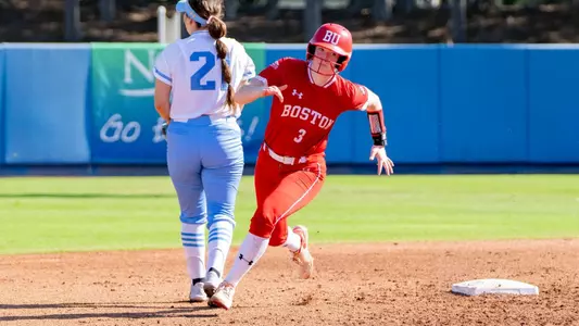 Addie Lucier is rushing toward third on a hit toward the outfield.