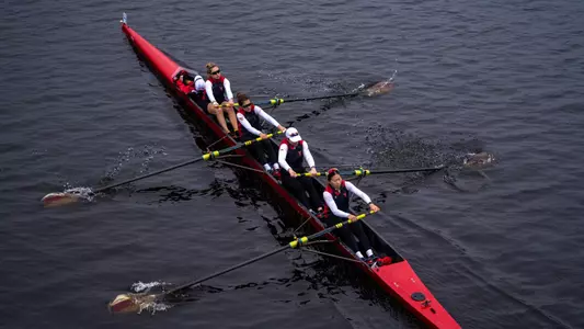 Photo of the BU Lightweight 4+ racing on the Charles River.