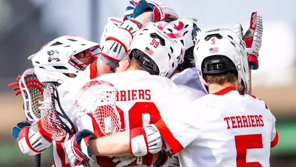 Men's lacrosse players celebrate a goal against Lehigh