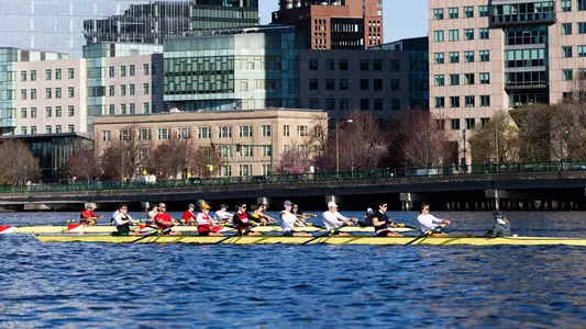 Photo of the BU Men's Rowing team practicing on the Charles River.