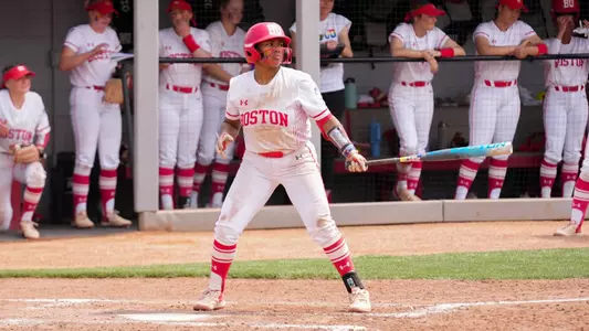 Kyomi Apalit has a practice swing at home plate before Army throws a pitch toward her.