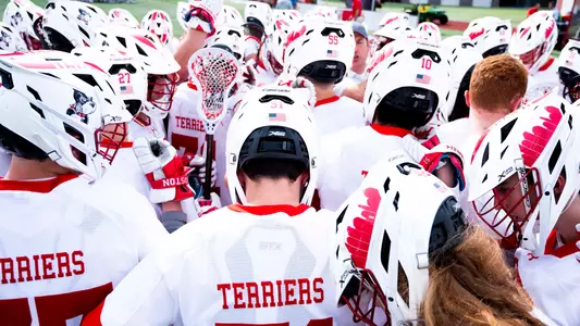 Men's lacrosse players huddle before a game