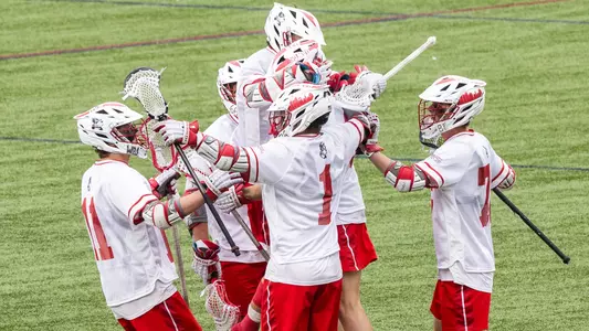 BU men's lacrosse players celebrate a goal