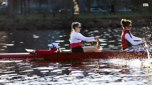 Photo of a BU Women's Rowing crew on the Charles River.