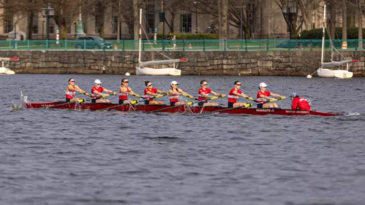 Photo of a BU Lightweight Rowing 8+ racing on the Charles River.