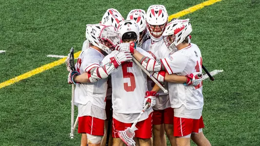 Men's lacrosse players celebrating a goal