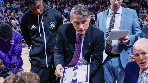 New BU men's basketball assistant coach Matt Brady holds a whiteboard during a media timeout while at High Point