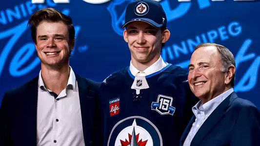 Sascha Boumedienne poses with Eric Comrie and NHL Commissioner Gary Bettman after being selected by the Winnipeg Jets in the opening round of the 2025 NHL Draft
