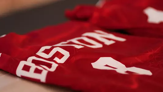 Photo of a BU women's soccer jersey sitting on the bench.