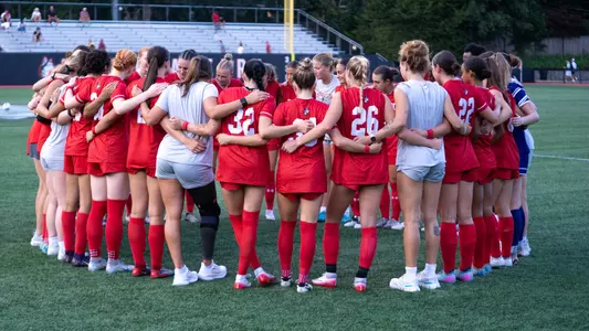 Photo of the BU women's soccer team huddling up.