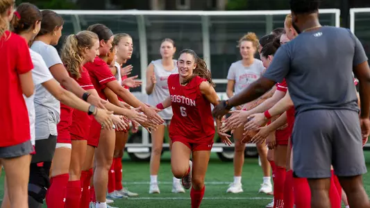 Photo of women's soccer junior Sam Aronson racing out from the starting lineup.