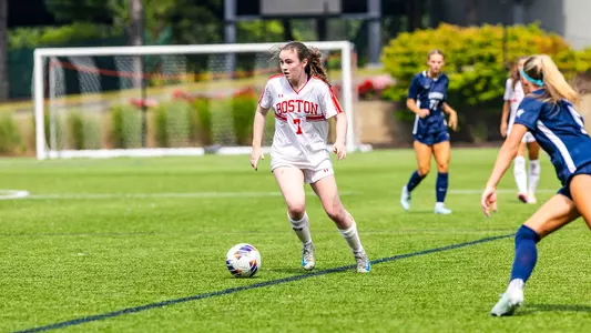 Photo of women's soccer freshman Georgia Prouty dribbling the ball against UNH.