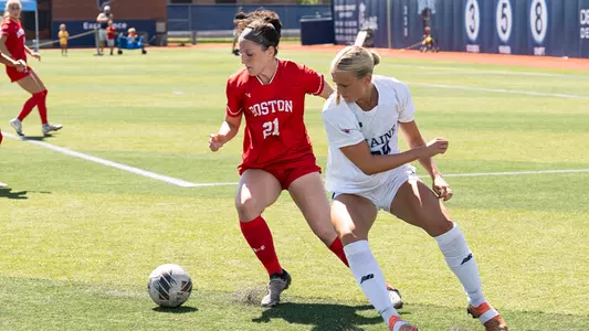 Mackenzie Stickelman dribbling against a Maine defender