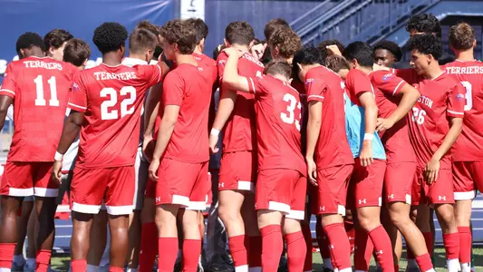 Men's Soccer team huddles in a circle before the start of game at New Hampshire.