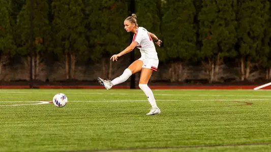 Photo of BU women's soccer senior Mackenzie Stickelman kicking the ball at Nickerson Field.