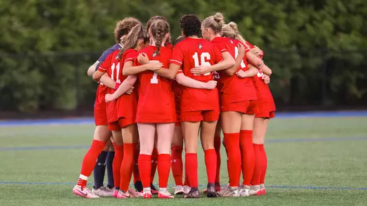 Photo of a BU Women's Soccer Team Huddle at UMass Lowell.