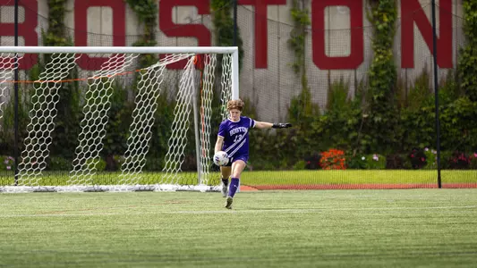 Photo of BU women's soccer goalkeeper Susan Shobeiri kicking the ball at Nickerson Field.