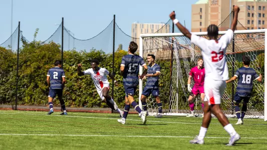 Dylan Williams and Ethan Gill are shown celebrating Andrea Di Blasio's goal with arms up in the air