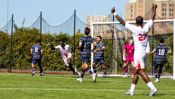 Dylan Williams and Ethan Gill are shown celebrating Andrea Di Blasio's goal with arms up in the air