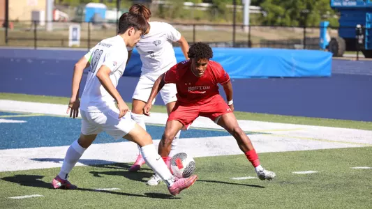 Austin Mobray tries to defend against a UNH player with the ball