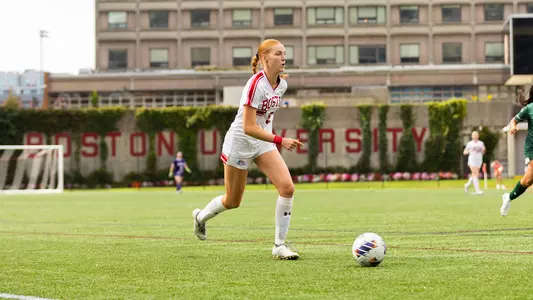 Photo of women's soccer junior Ciara Kennedy dribbling the ball at Nickerson Field.