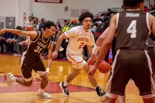 Chance Gladden dribbles the ball up the court while guarded by Lehigh defender