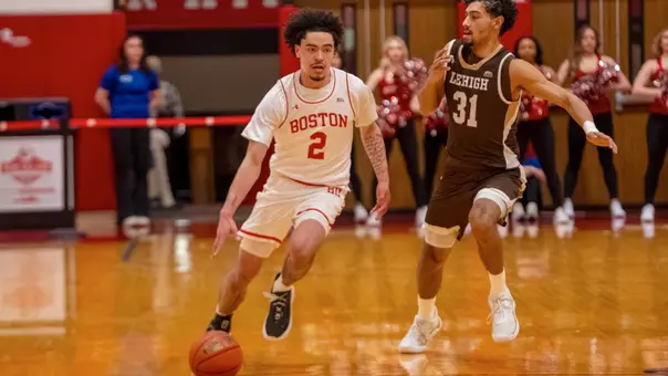 Chance Gladden dribbles the ball up the court while guarded by a Lehigh defender